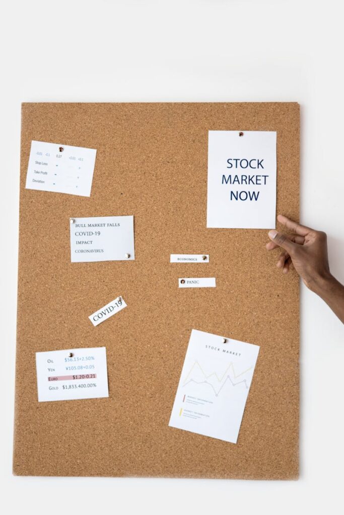 Stock market concepts pinned on a cork board for visual reference.